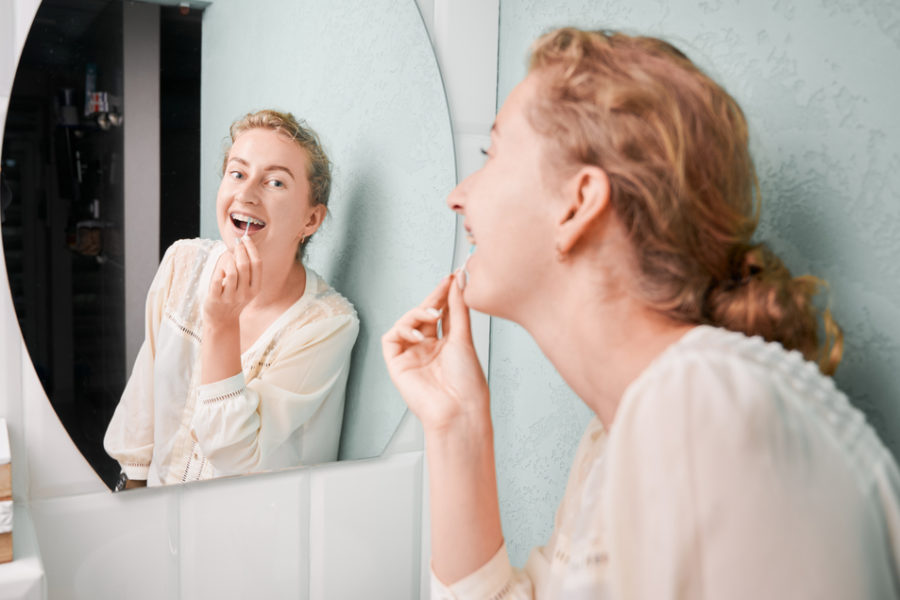 woman-learning-how-to-flossing-with-braces