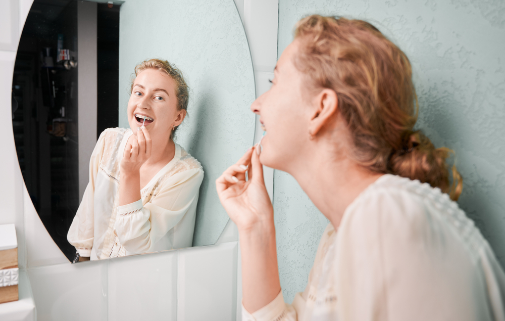 woman-learning-how-to-flossing-with-braces